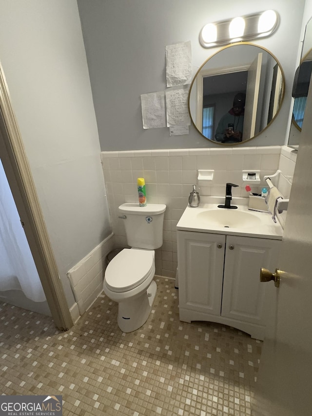 2461 Mcalpin Ter, East Point, GA 30344 - bathroom featuring vanity, wainscoting, tile patterned floors, and tile walls
