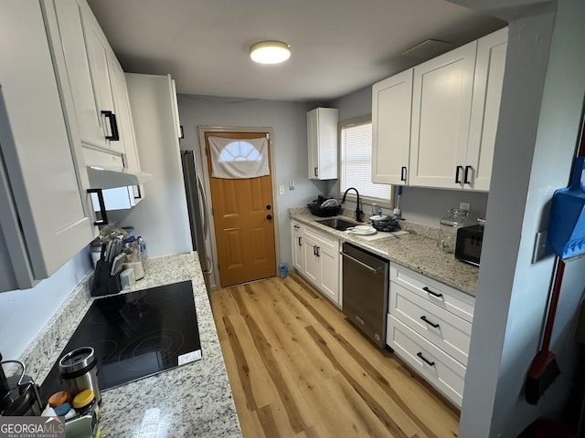 2461 Mcalpin Ter, East Point, GA 30344 - kitchen with black appliances, white cabinets, light wood-style flooring, and light stone countertops