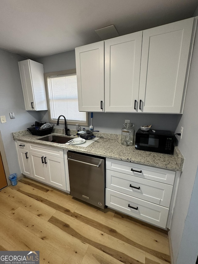 2461 Mcalpin Ter, East Point, GA 30344 - kitchen with dishwasher, light wood-style floors, white cabinets, and light stone countertops