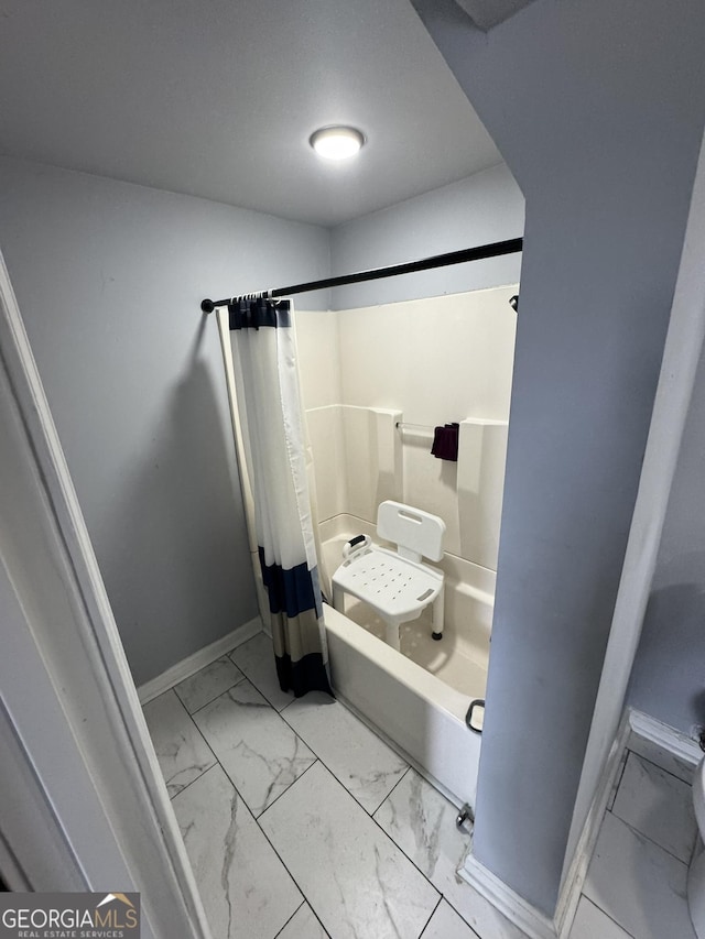 2461 Mcalpin Ter, East Point, GA 30344 - full bathroom featuring marble look tiles and baseboards