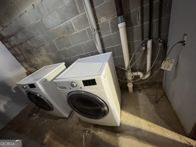 2461 Mcalpin Ter, East Point, GA 30344 - laundry room with washer and dryer and concrete block wall
