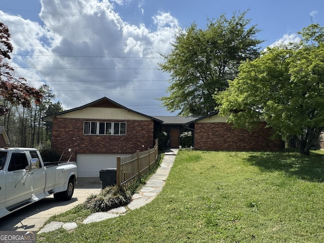 2461 Mcalpin Ter, East Point, GA 30344 - view of front of property with a front lawn, an attached garage, concrete driveway, and brick siding