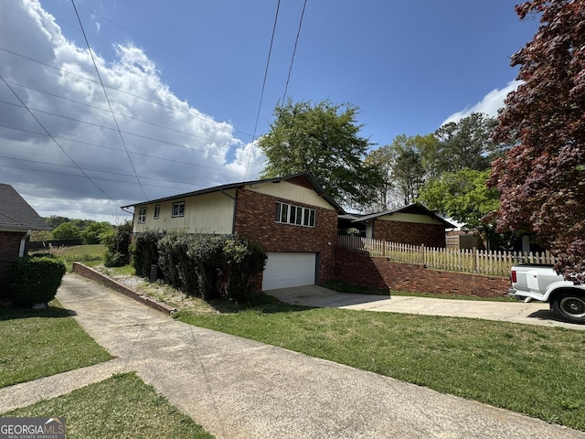 2461 Mcalpin Ter, East Point, GA 30344 - view of side of home with concrete driveway, brick siding, and an attached garage