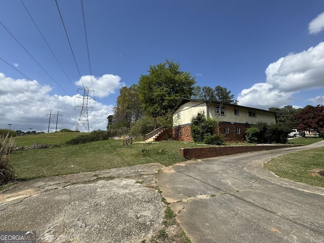 2461 Mcalpin Ter, East Point, GA 30344 - view of home's exterior featuring brick siding and a yard
