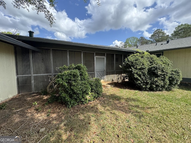 2461 Mcalpin Ter, East Point, GA 30344 - back of house with a sunroom, a yard, and board and batten siding