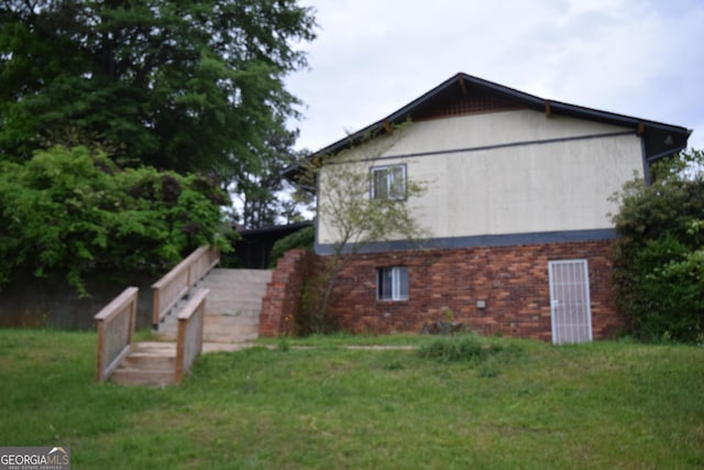 2461 Mcalpin Ter, East Point, GA 30344 - view of side of home featuring a yard and brick siding