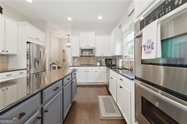 3883 Wakefield Hall Sq SE, Smyrna, GA 30080 - kitchen with stainless steel appliances, gray cabinets, a sink, white cabinets, and recessed lighting