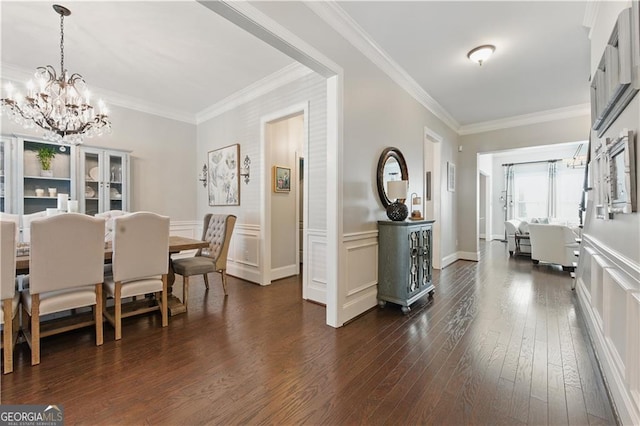 3883 Wakefield Hall Sq SE, Smyrna, GA 30080 - dining area with a chandelier, ornamental molding, dark wood finished floors, and a decorative wall