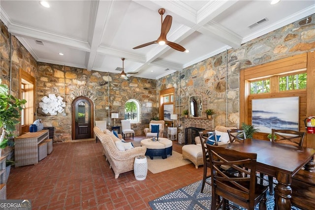 3883 Wakefield Hall Sq SE, Smyrna, GA 30080 - living room with beam ceiling, a brick fireplace, coffered ceiling, ornamental molding, and brick patterned flooring