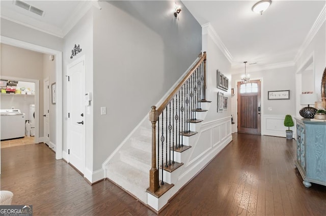 3883 Wakefield Hall Sq SE, Smyrna, GA 30080 - entrance foyer with washer / dryer, stairway, dark wood-style floors, a chandelier, and ornamental molding