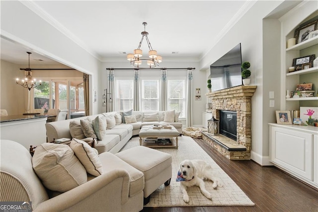 3883 Wakefield Hall Sq SE, Smyrna, GA 30080 - living room featuring a chandelier, dark wood finished floors, a stone fireplace, crown molding, and built in features