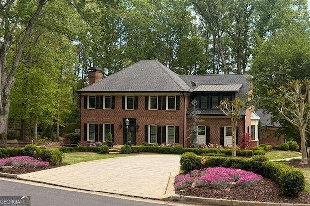5790 Heards Forest Dr, Atlanta, GA 30328 - view of front of house with a chimney, driveway, and brick siding
