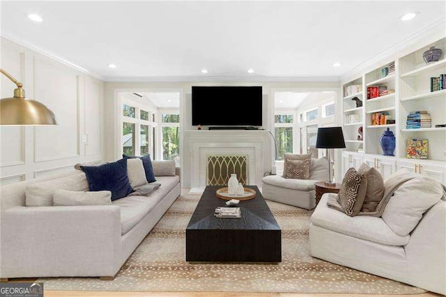 5790 Heards Forest Dr, Atlanta, GA 30328 - living room featuring a fireplace, a decorative wall, built in features, recessed lighting, and ornamental molding