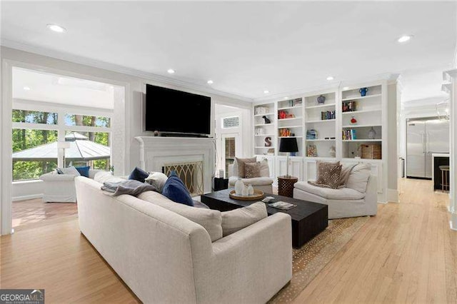 5790 Heards Forest Dr, Atlanta, GA 30328 - living room with crown molding, recessed lighting, light wood-type flooring, and a fireplace