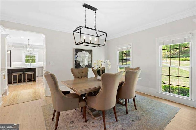 5790 Heards Forest Dr, Atlanta, GA 30328 - dining space with a chandelier, ornamental molding, and light wood-style flooring