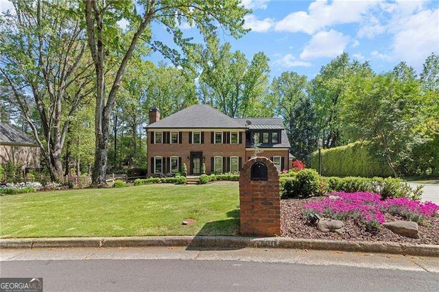 5790 Heards Forest Dr, Atlanta, GA 30328 - colonial inspired home with a front yard and a chimney