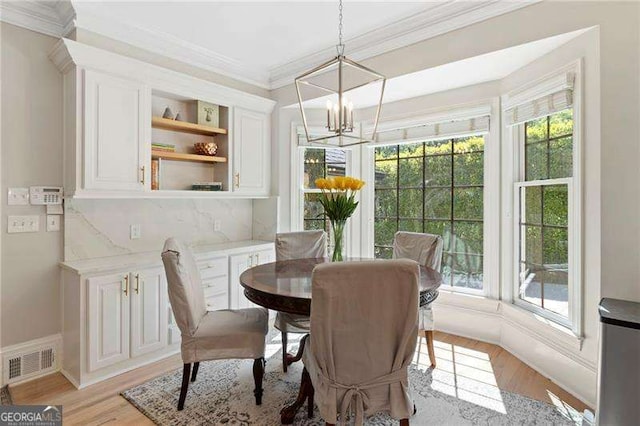 5790 Heards Forest Dr, Atlanta, GA 30328 - dining room featuring a chandelier, ornamental molding, visible vents, and light wood-type flooring