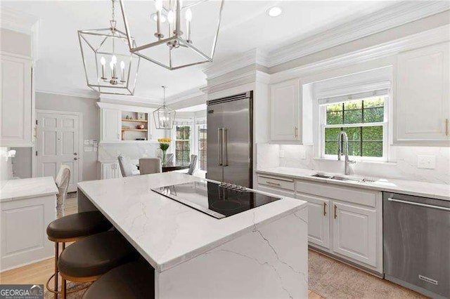 5790 Heards Forest Dr, Atlanta, GA 30328 - kitchen with a kitchen island, a chandelier, appliances with stainless steel finishes, and a sink