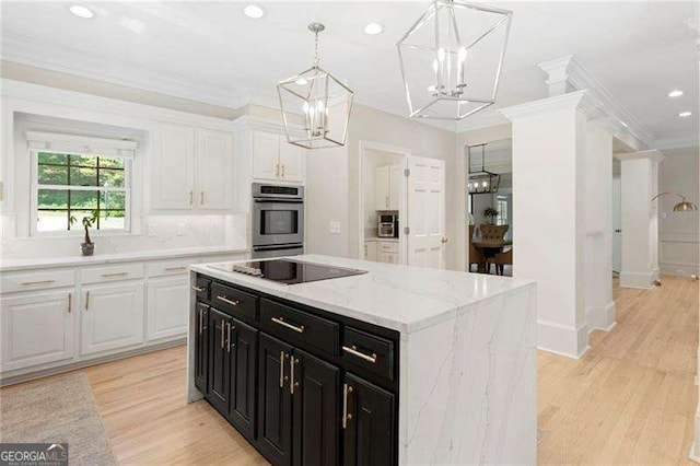 5790 Heards Forest Dr, Atlanta, GA 30328 - kitchen featuring dark cabinetry, white cabinetry, an inviting chandelier, and light wood finished floors
