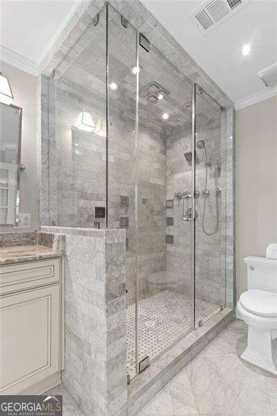 5790 Heards Forest Dr, Atlanta, GA 30328 - bathroom with vanity, toilet, visible vents, ornamental molding, and a stall shower