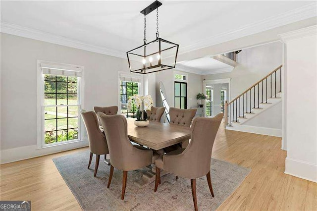 5790 Heards Forest Dr, Atlanta, GA 30328 - dining space with stairs, a notable chandelier, ornamental molding, and light wood-style floors