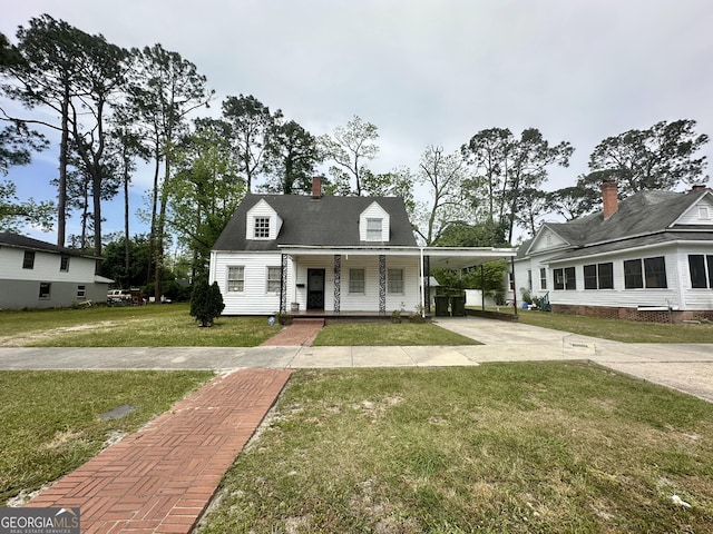 623 Mcdonald St, Waycross, GA 31503 - cape cod home featuring concrete driveway, covered porch, a front yard, a carport, and a chimney