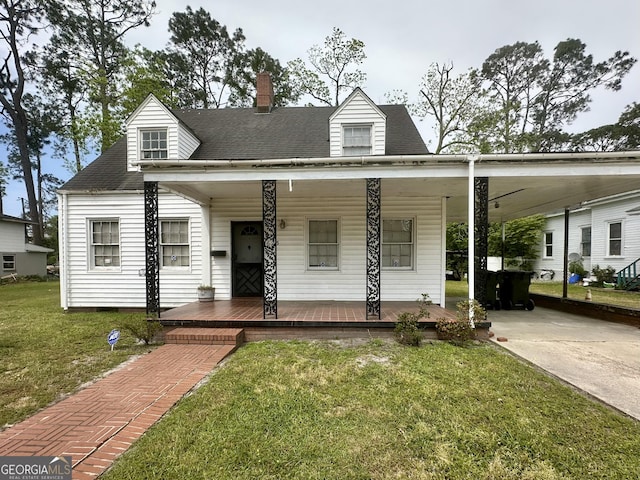 623 Mcdonald St, Waycross, GA 31503 - view of front facade with covered porch, a front yard, a chimney, a carport, and concrete driveway
