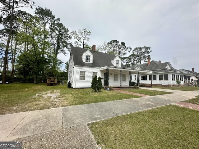 623 Mcdonald St, Waycross, GA 31503 - view of front of house with a porch, a front yard, and a chimney