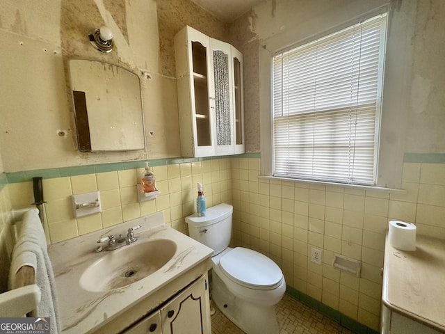 623 Mcdonald St, Waycross, GA 31503 - bathroom featuring tile walls, vanity, tile patterned flooring, and a wainscoted wall