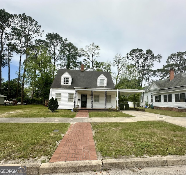 623 Mcdonald St, Waycross, GA 31503 - view of front of house with a porch, concrete driveway, a front yard, a carport, and a chimney