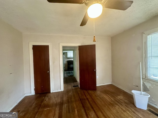 623 Mcdonald St, Waycross, GA 31503 - unfurnished bedroom with wood finished floors and a ceiling fan