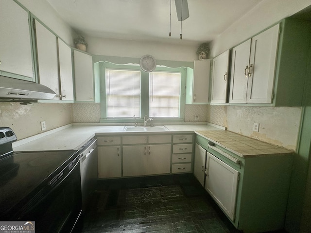 623 Mcdonald St, Waycross, GA 31503 - kitchen with black electric range oven, under cabinet range hood, dishwasher, white cabinetry, and tile countertops