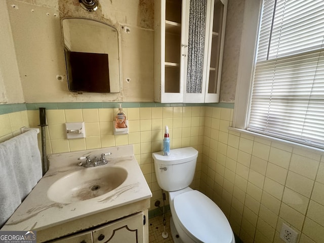 623 Mcdonald St, Waycross, GA 31503 - half bathroom with vanity, tile walls, and a wainscoted wall