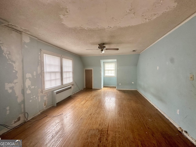 623 Mcdonald St, Waycross, GA 31503 - spare room featuring radiator, wood finished floors, ceiling fan, and a textured ceiling