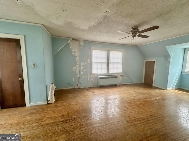 623 Mcdonald St, Waycross, GA 31503 - additional living space with ceiling fan, wood finished floors, radiator, and a textured ceiling