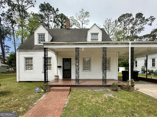 623 Mcdonald St, Waycross, GA 31503 - view of front of house featuring a porch, a front yard, a chimney, a shingled roof, and a carport