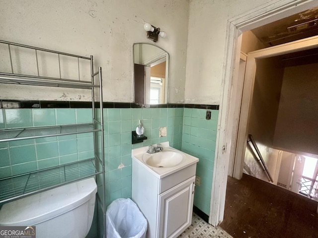 623 Mcdonald St, Waycross, GA 31503 - bathroom featuring vanity, tile walls, and a wainscoted wall