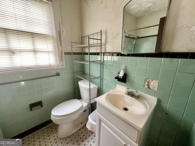 623 Mcdonald St, Waycross, GA 31503 - full bath featuring tile walls, vanity, a wainscoted wall, a shower, and tile patterned floors