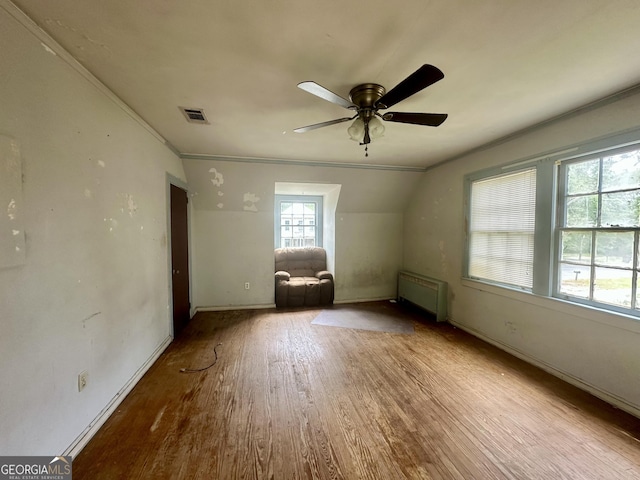 623 Mcdonald St, Waycross, GA 31503 - empty room featuring wood finished floors, radiator, ceiling fan, and crown molding