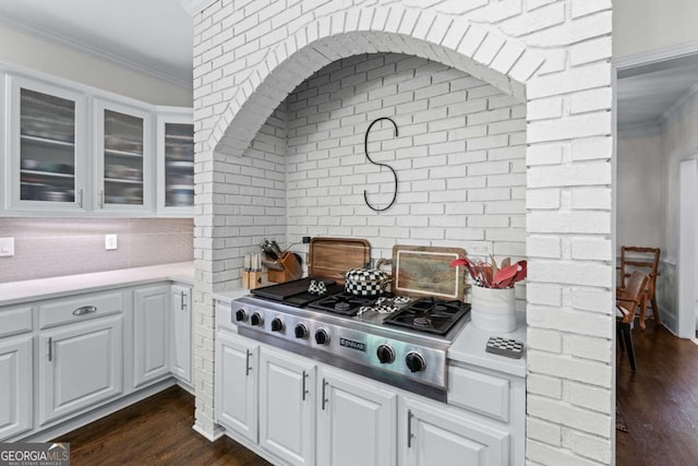 1811 Fountain Hill Ct, Duluth, GA 30097 - kitchen featuring stainless steel gas stovetop, glass insert cabinets, crown molding, dark wood-style floors, and light countertops