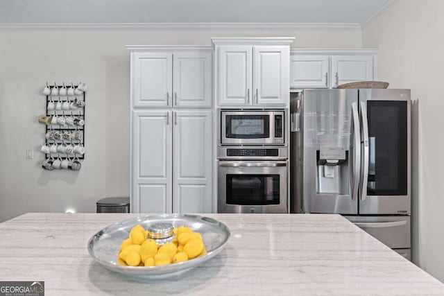 1811 Fountain Hill Ct, Duluth, GA 30097 - kitchen with appliances with stainless steel finishes, light stone countertops, ornamental molding, and white cabinetry