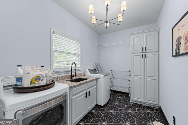 1811 Fountain Hill Ct, Duluth, GA 30097 - laundry room featuring a chandelier, cabinet space, and separate washer and dryer