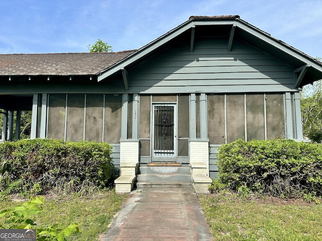 2409 Dorothy St, Waycross, GA 31501 - view of front of house with a sunroom, brick siding, and entry steps