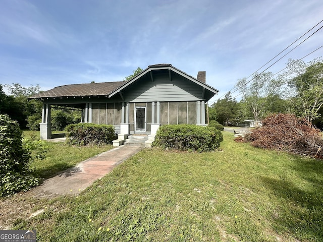 2409 Dorothy St, Waycross, GA 31501 - view of front of home with a chimney and a front lawn