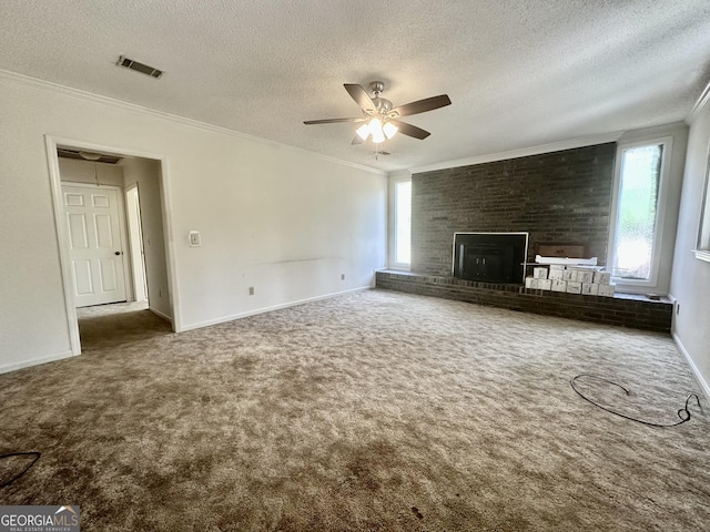 2409 Dorothy St, Waycross, GA 31501 - unfurnished living room featuring healthy amount of natural light, ornamental molding, a textured ceiling, a ceiling fan, and carpet flooring