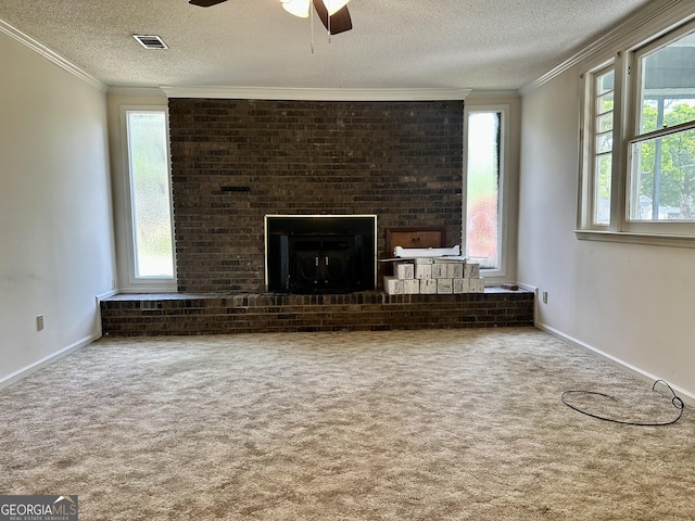 2409 Dorothy St, Waycross, GA 31501 - unfurnished living room with ceiling fan, carpet, a textured ceiling, crown molding, and a fireplace