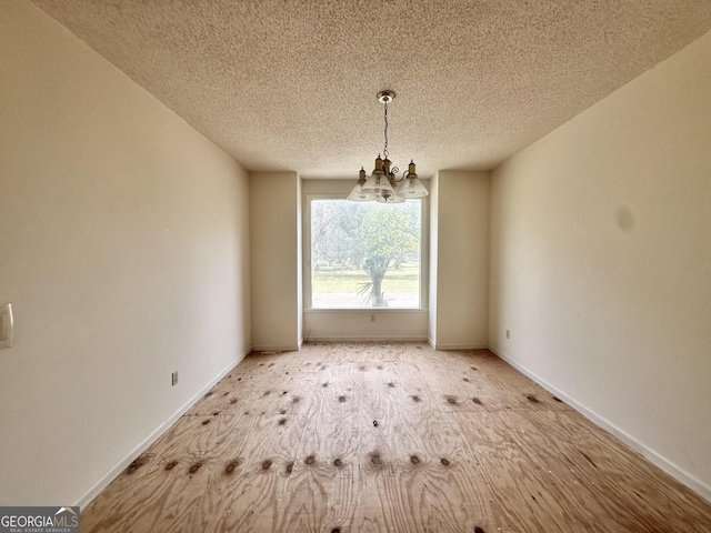 2409 Dorothy St, Waycross, GA 31501 - unfurnished dining area featuring a chandelier, a textured ceiling, and baseboards