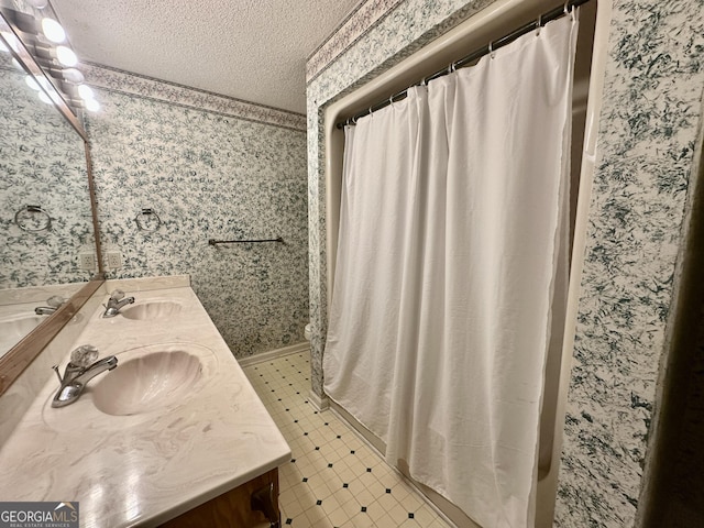 2409 Dorothy St, Waycross, GA 31501 - bathroom with a textured ceiling, double vanity, wallpapered walls, and a shower with shower curtain