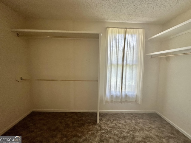 2409 Dorothy St, Waycross, GA 31501 - unfurnished bedroom featuring carpet, baseboards, and a textured ceiling