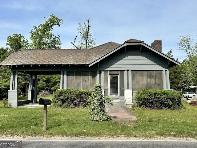 2409 Dorothy St, Waycross, GA 31501 - view of front of house featuring a chimney, a front yard, and a shingled roof